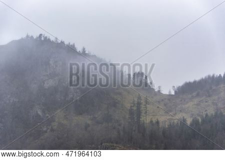 Beautiful Calm Peaceful Winter Landscape Over Thirlmere In Lake District With Fog And Layers Of Tree