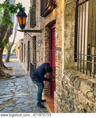 Colonia Del Sacramento, Uruguay - November 1 2022: A Person Is Standing Outside A Colonial House Wit