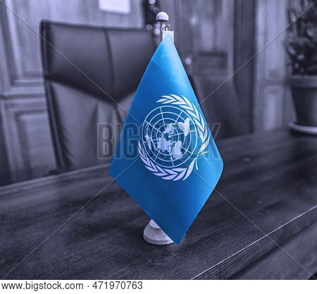 The Hague, Netherlands - December 15 2022: A Blue United Nations Flag Is Standing On A Desk Of An Of