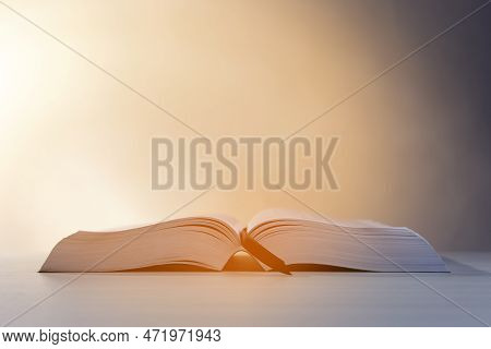 Open Bible On White Wooden Table Against Beige Background. Space For Text