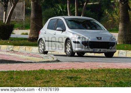 Side, Turkey -january 27, 2023:    Silver Peugeot 307   Is  Driving   On The Street On A Warm Summer