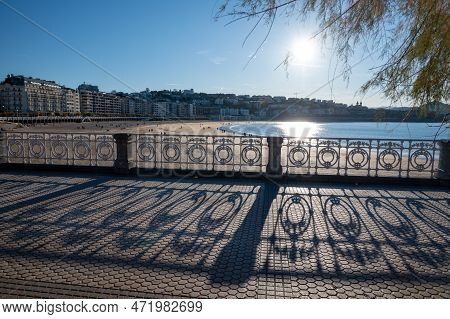 Walking On Promenade Along White Sandy La Concha Beach In Central Part Of Donostia Or San Sebastian