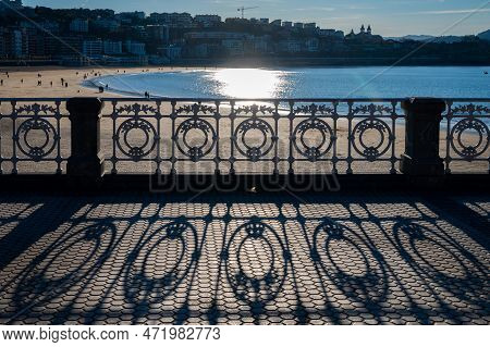 Walking On Promenade Along White Sandy La Concha Beach In Central Part Of Donostia Or San Sebastian