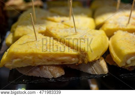 Typical Snack Of Basque Country, Pinchos Or Pinxtos, Small Piece Of Bread With Egg Omelette, Differe