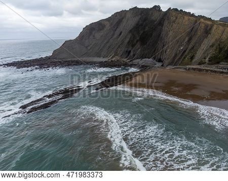 View On Sandy Beach, Rocks And Atlantic Ocean In Zumaia Touristic Ciry, Basque Country, Spain