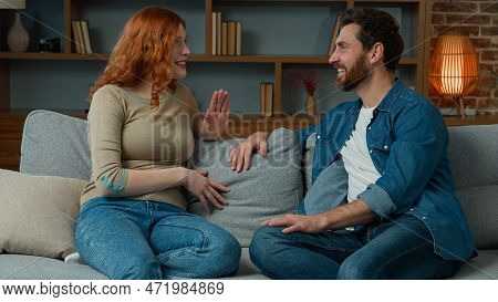 Woman Talking With Man At Home Joyful Caucasian Couple Sit On Couch Redhead Girl Telling Funny Story
