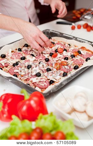 Men cooking fresh italian pizza close up