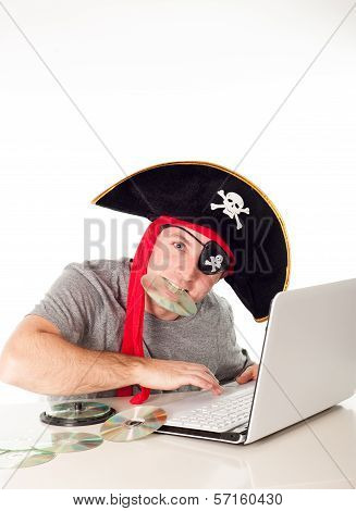 Man In Pirate Hat Downloading Music On A Laptop