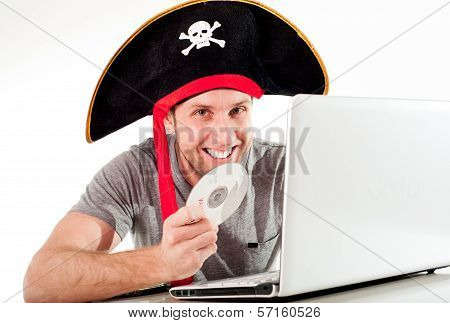 Man In Pirate Hat Downloading Music On A Laptop