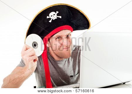 Man In Pirate Hat Downloading Music On A Laptop
