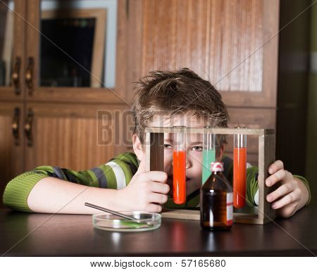 The boy with colorful flasks. Education.