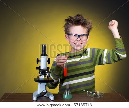 Little boy making science experiments. Education.