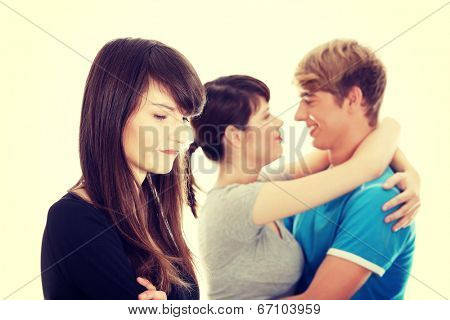 Sad brunette girl jealousy about her friend.