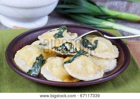 Homemade ravioli stuffed with ricotta and spinach on a fork