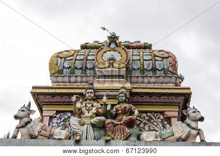 Architectural monument of Hindu God Shiva and Goddess Parvati at the entrance of old temple