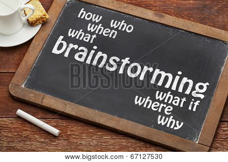 brainstorming word with who, what, when, where, how questions on a vintage slate blackboard with a cup of coffee