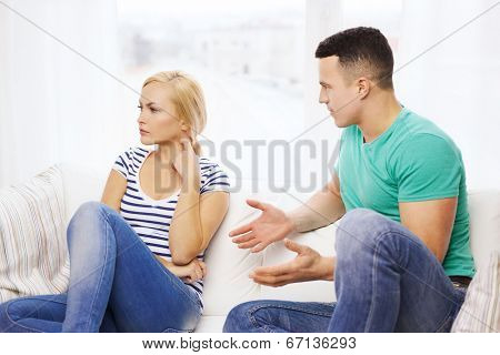 love, family and happiness concept - unhappy couple having argument at home