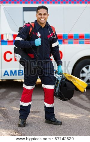 happy indian paramedic carrying portable medical equipments