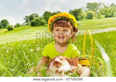 Smiling girl wearing flowers circlet and rabbit
