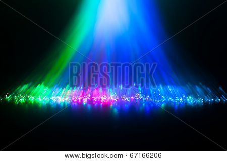 Glowing tips of optical fiber in dark.