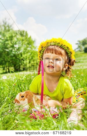 Happy girl wearing flowers circlet and rabbit