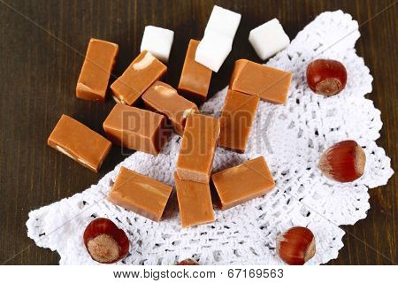 Many toffee on napkin on wooden table
