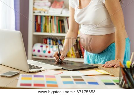 Pregnant woman working from home