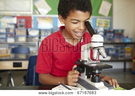 Boy in science class with microscope