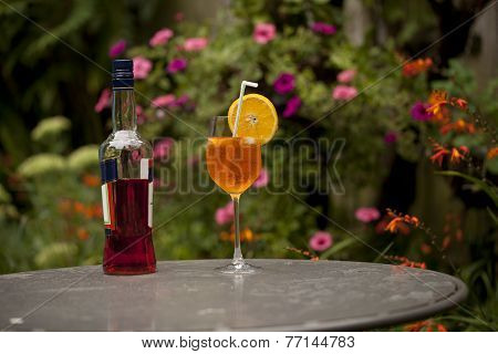 A Bottle of Aperativo and a glass of cool spritzer