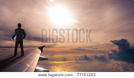 Businessman Holding Safety Helmet Standing On Airplane Wing, Successful Business Concept