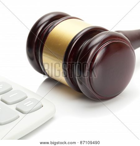 Wooden Judge's Gavel And Calculator Right Next To It