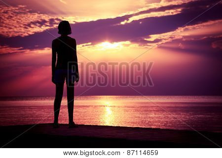 Silhouette of Young Woman Watching Sea Sunset