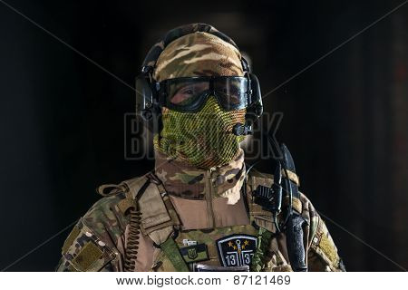 Airsoft strikeball player in uniform. Soldier full gear. Man with a gun is playing airsoft