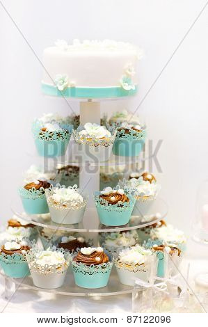 Wedding Cake And Cupcakes In Brown And Cream In Blue, White And Brown.