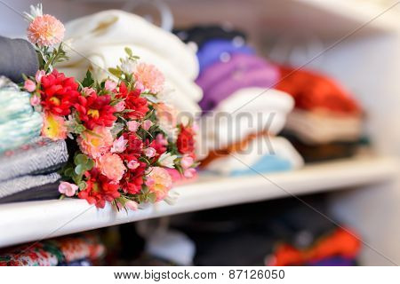 Flower Bouquet on Clothing Shelf