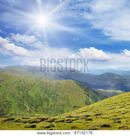 High mountains and sun on blue sky