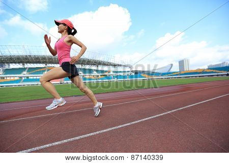 young fitness woman runner running on track
