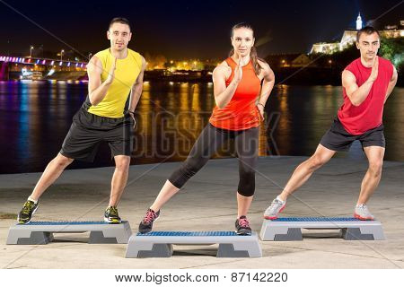 Active young people on outdoor step training