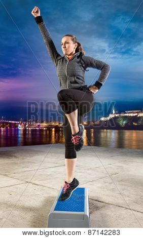 Fit woman exercising on stepper