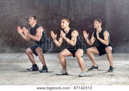 three young healthy men exercising