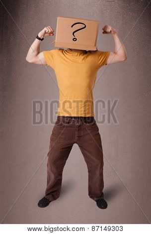 Young man standing and gesturing with a cardboard box on his head with question mark
