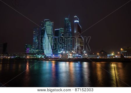 Picturesque Night View Of The Moscow City Across The River Moscow With Reflection In Water,