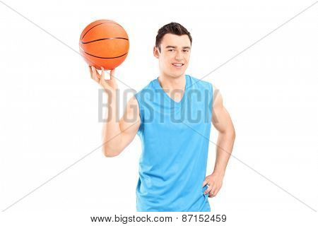 Young smiling basketball player in blue dress posing with a ball isolated on white background