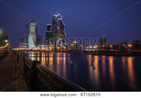Picturesque Night View Of The Moscow City Across The River Moscow With Reflection In Water,