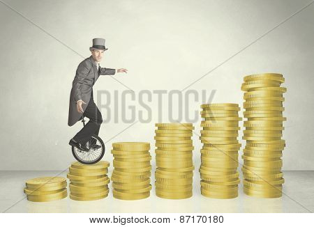 Business man riding monocycle up on coin graph concept on background
