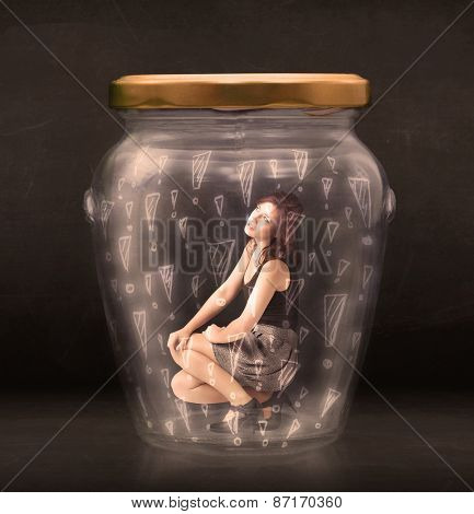 Business woman trapped in jar with exclamation marks concept on bakcground