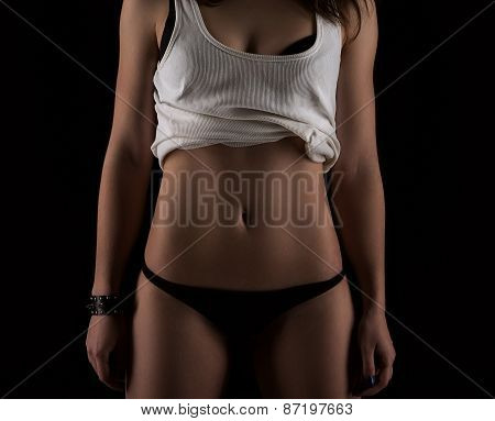 Sexy Slim Fit Woman Body. Muscled Abdomen. Sportswear. Dark Background