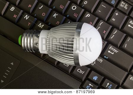Close up Led Bulb at the keyboard background.