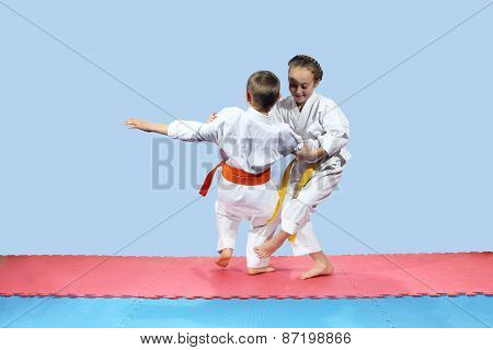 Girl with yellow belt makes slicing down under leg