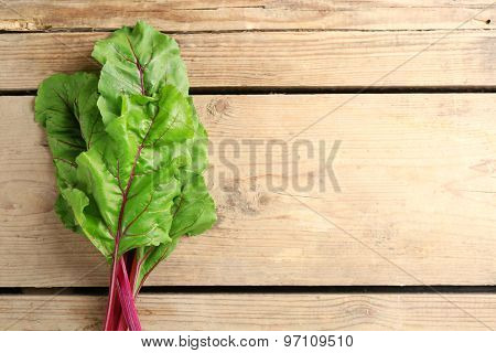 Fresh swiss chard on wooden table, close up